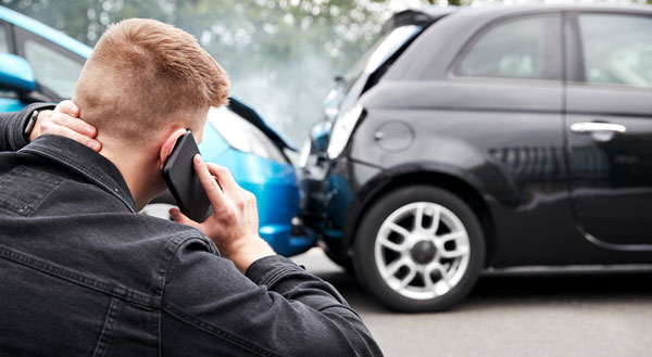 a person on the phone at the scene of an accident